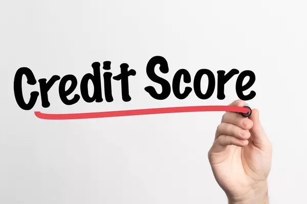 Human hand writing Credit Score on whiteboard
