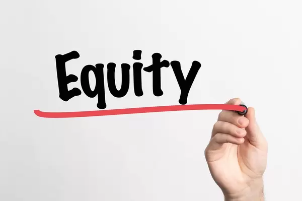 Human hand writing Equity on whiteboard