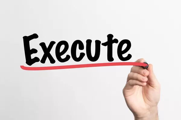 Human hand writing Execute on whiteboard