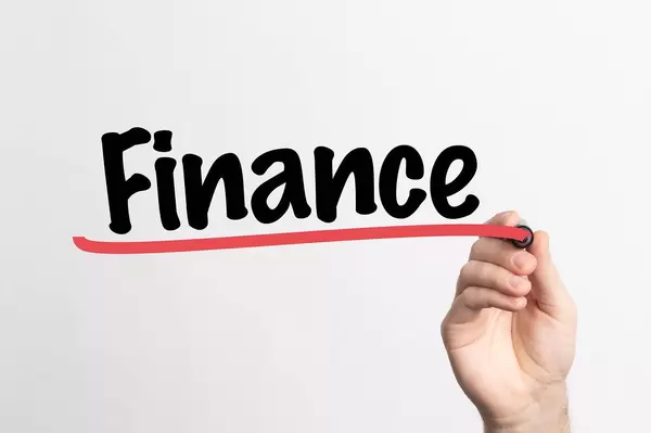 Human hand writing Finance on whiteboard
