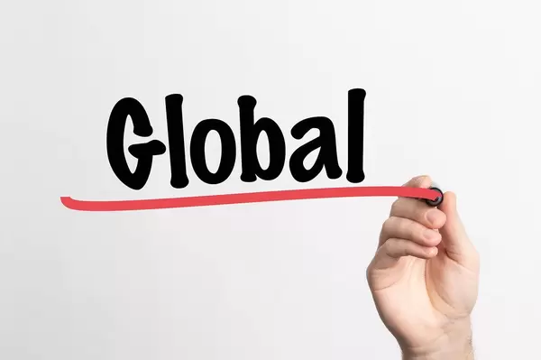 Human hand writing Global on whiteboard
