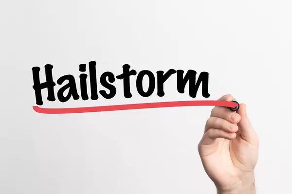 Human hand writing Hailstorm on whiteboard