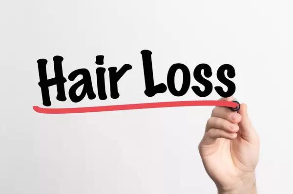 Human hand writing Hair Loss on whiteboard