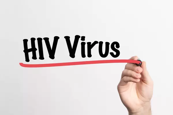 Human hand writing HIV Virus on whiteboard