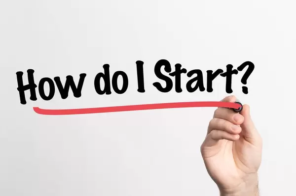 Human hand writing How do I Start on whiteboard