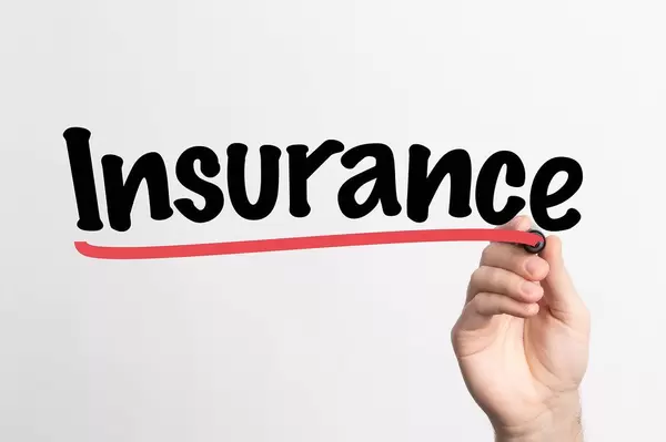 Human hand writing Insurance on whiteboard