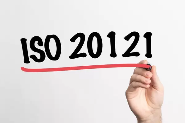 Human hand writing ISO 20121 on whiteboard