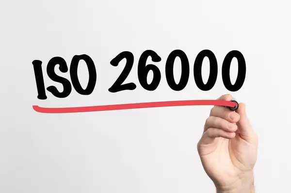 Human hand writing ISO 26000 on whiteboard