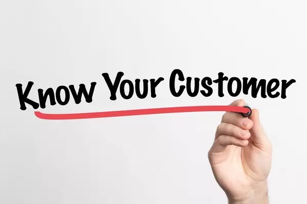 Human hand writing Know Your Customer on whiteboard