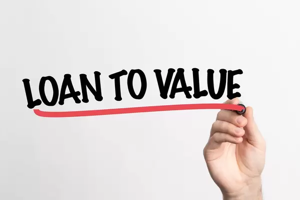 Human hand writing Loan to Value on whiteboard