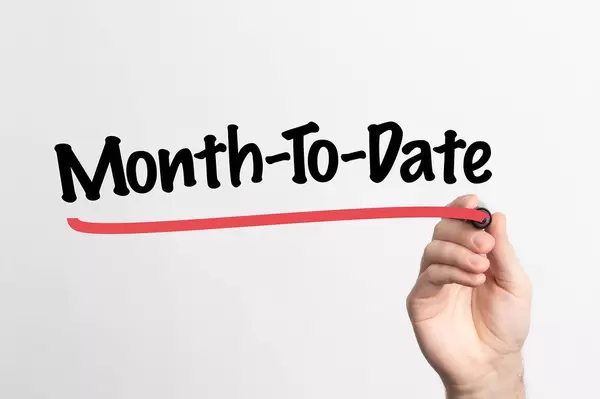 Human hand writing Month-To-Date on whiteboard