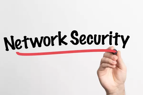 Human hand writing Network Security on whiteboard