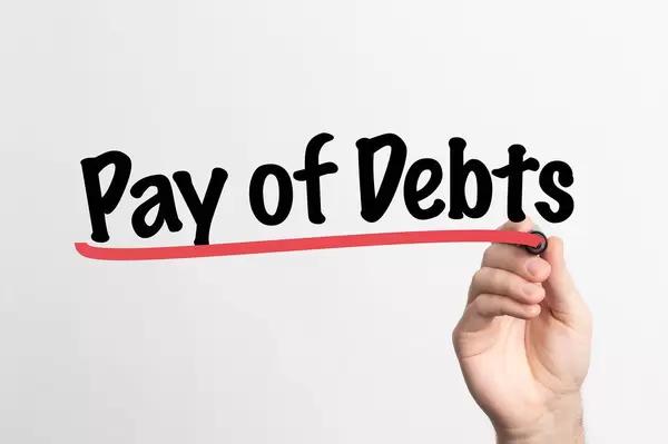 Human hand writing Pay of Debts on whiteboard