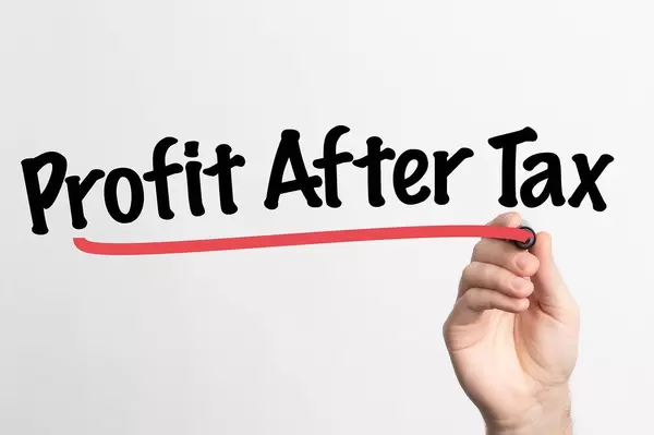 Human hand writing Profit After Tax on whiteboard