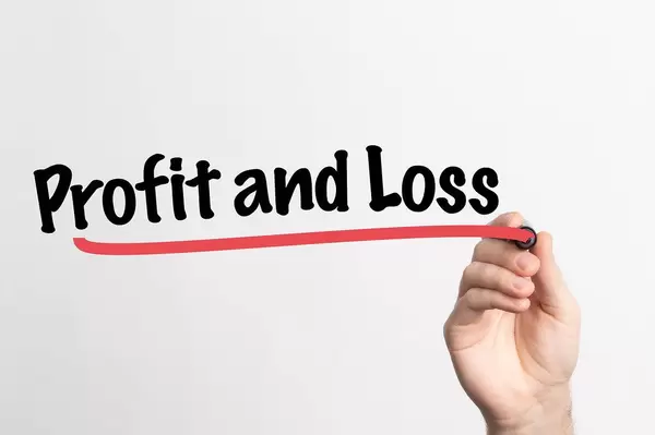 Human hand writing Profit and Loss on whiteboard
