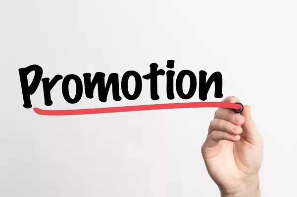 Human hand writing Promotion on whiteboard