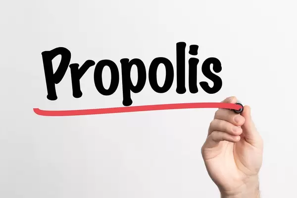 Human hand writing Propolis on whiteboard