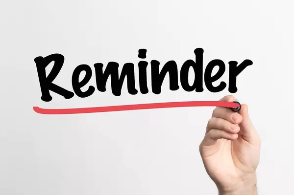 Human hand writing Reminder on whiteboard