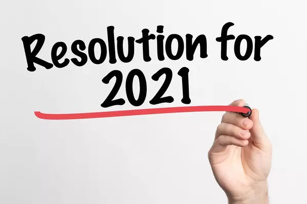 Human hand writing Resolution for 2021 on whiteboard