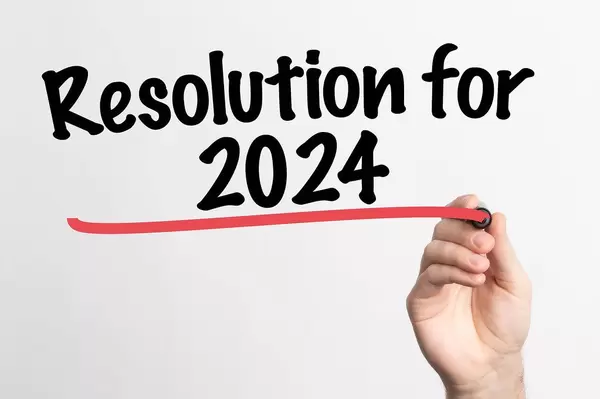 Human hand writing Resolution for 2024 on whiteboard