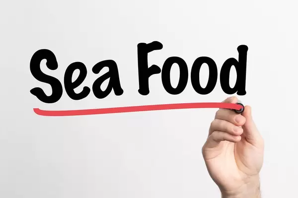 Human hand writing Sea Food on whiteboard