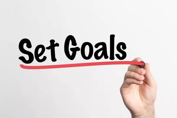 Human hand writing Set Goals on whiteboard