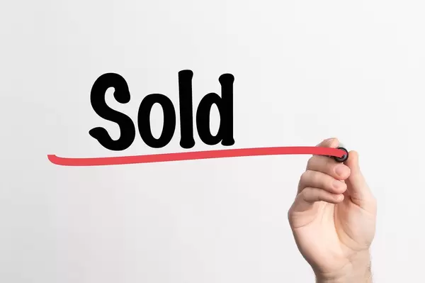 Human hand writing Sold on whiteboard