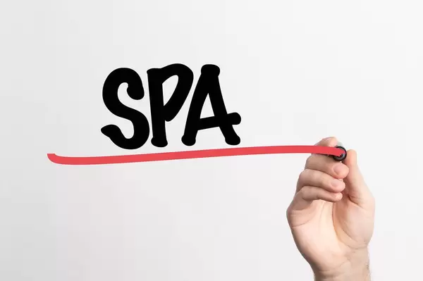 Human hand writing SPA on whiteboard