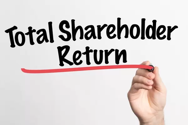 Human hand writing Total Shareholder Return on whiteboard