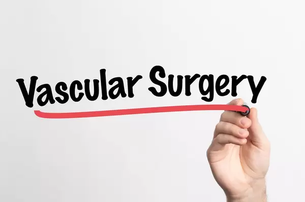 Human hand writing Vascular Surgery on whiteboard