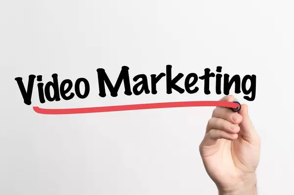 Human hand writing Video Marketing on whiteboard