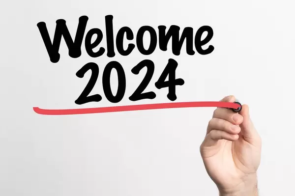 Human hand writing Welcome 2024 on whiteboard