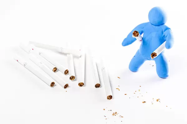 Human model with broken cigarette, smoking cessation concept