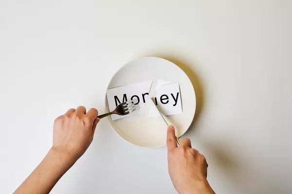 Hungry person eating money
