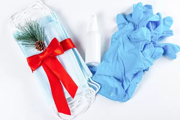 Hygienic face masks antiseptic and medical gloves with red ribbon, top view