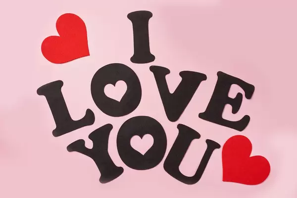 I love you words made of paper cuts on pink