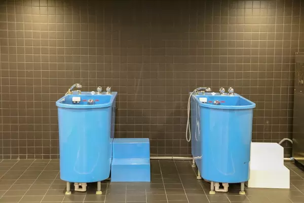 Ice bath in blue bathtubs for recovery sessions after soccer training, exhibited at the Camp Nou Stadium Tour & FC Barcelona Museum, Spain