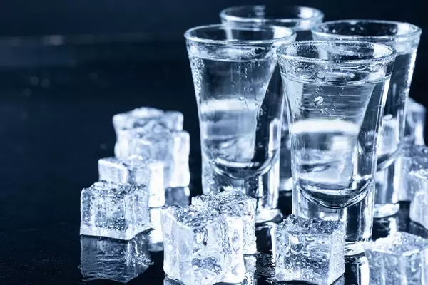 Ice cubes and glasses with cool vodka