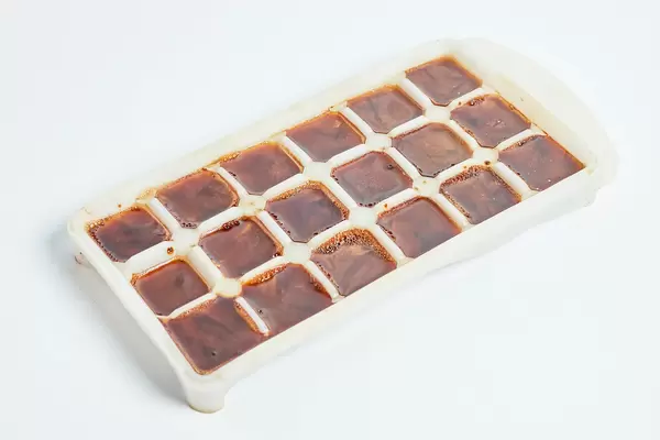 Ice cubes made with coffee in ice cube tray