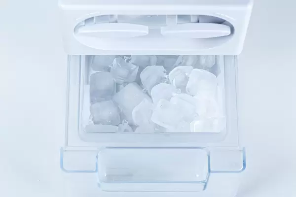 Ice from the fridge. Containers for ice in the refrigerator