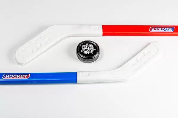 Ice hockey sticks and puck on white background