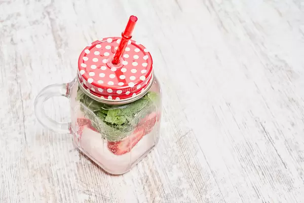 Iced summer drink cocktail with strawberry and fresh mint