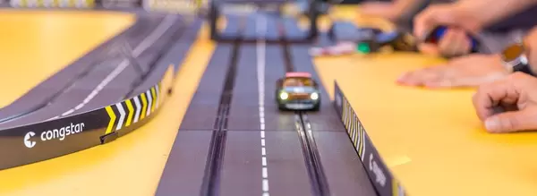 IFA-visitors play with lightning car on Carrera track racing game by Congstar