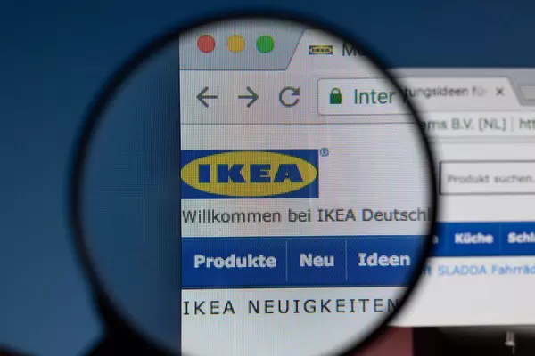Ikea-Logo am PC-Monitor, durch eine Lupe fotografiert