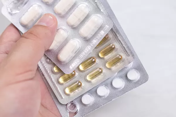 Immunity Tablets and Pills in the hand against Covid-19 virus