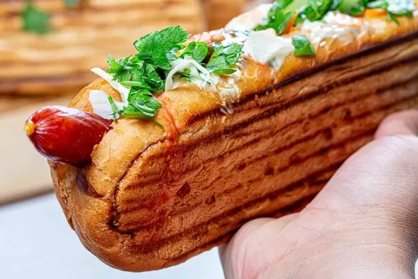 In a woman's hand hot dog grill, close-up (Flip 2019)