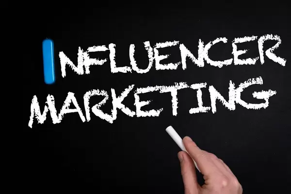 Influencer marketing text on blackboard