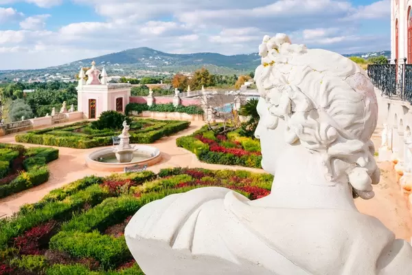 Inner garden of Pousada Palácio Estói with many beautiful sculptures