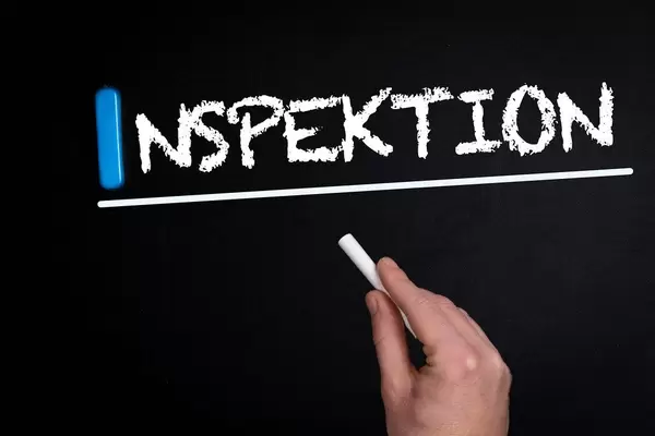 Inspektion text on blackboard