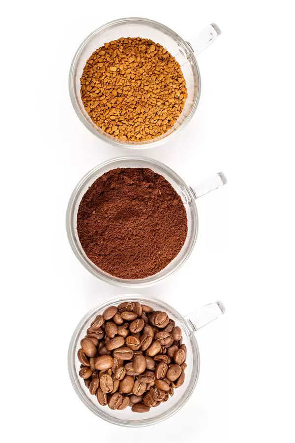 Instant, ground and coffee beans in glass cups on white, top view